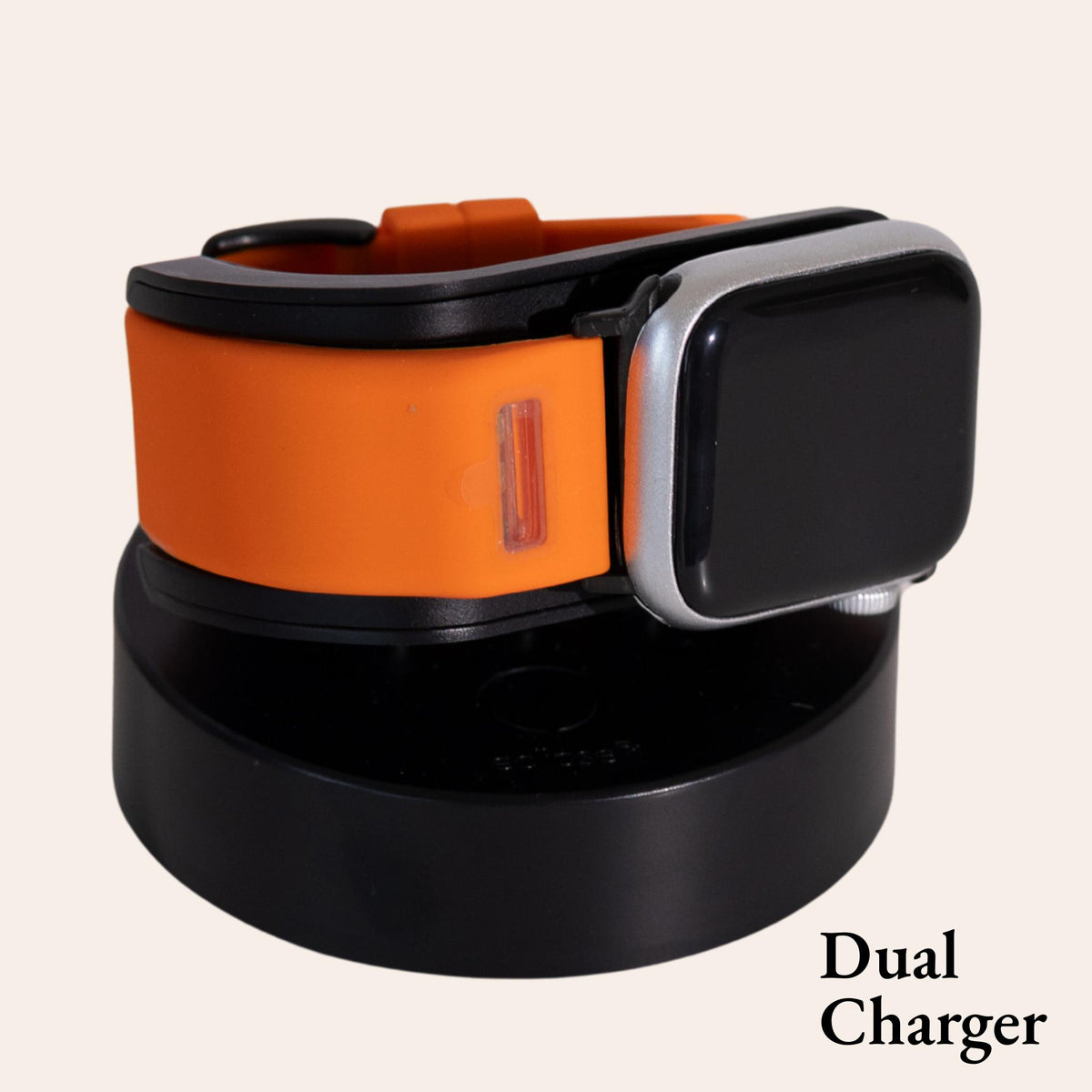 Orange BURŪV smart band for Apple Watch® resting on a black dual charging dock against a light beige background. The text 'Dual Charger' appears in the bottom right corner.