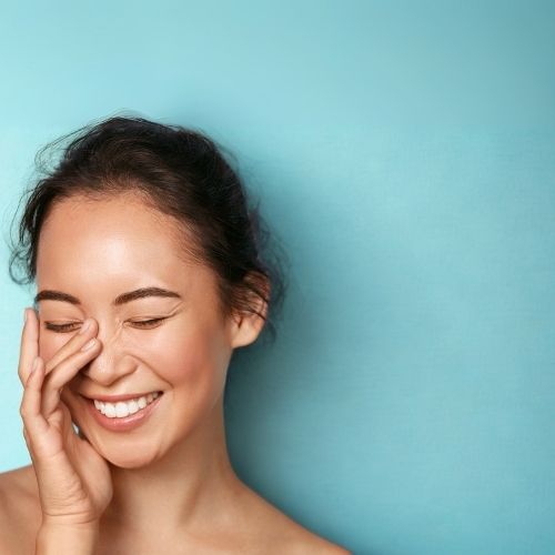 woman smiling on blue background